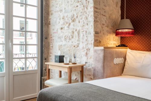 Un ou plusieurs lits dans un hébergement de l'établissement Boemio FLH Hotels