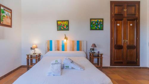 a bedroom with two beds and two night stands at Villa Fructus Vejer de la Frontera - El Palmar by Ruralidays in Cádiz
