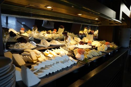 a buffet line with cheese and other food items at Manaspark Deluxe Hotel in Oludeniz