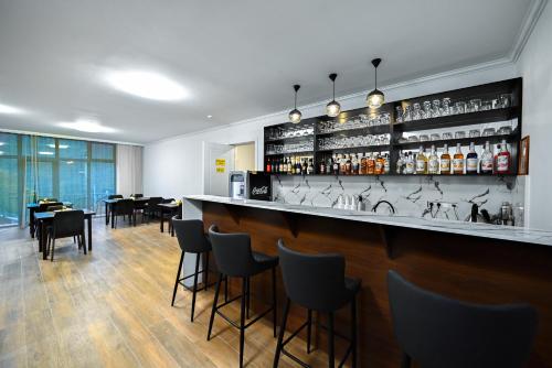 a bar in a restaurant with tables and chairs at Aurelia Hotel & Restaurant in Dilijan