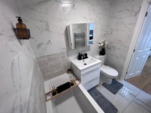 a white bathroom with a sink and a toilet at Luxury Birmingham City Centre Palace in Birmingham