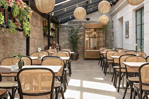 a row of tables and chairs in a restaurant at Donners Hotell in Visby