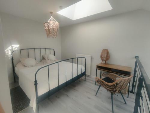a bedroom with a bed and a table and a chair at Lovely apartment Nadolnik in Poznań