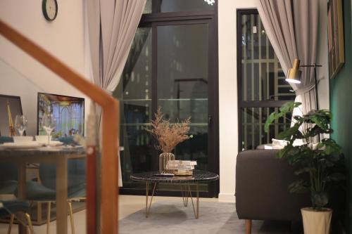 a living room with a table in front of a window at DingD0ng Home FelizEnVista 5-star facilities in Ho Chi Minh City