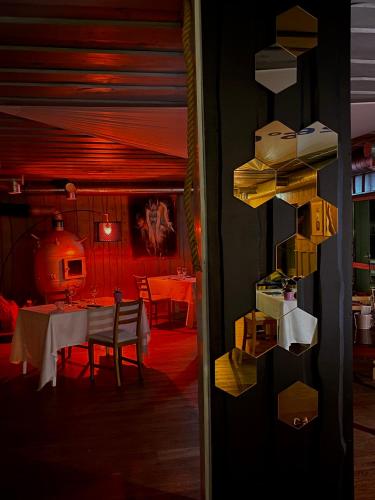 a dining room with a table and a dining room with a table and chairs at Vergi Sadam & Restoran Wirkes' in Vergi