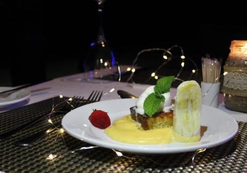 a plate of food with a dessert on a table at Lions Rock Rapids - Luxury Tented Camp in Hazyview