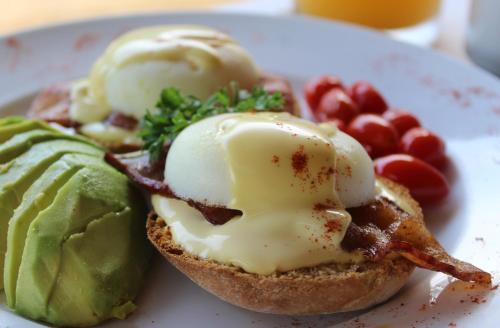 a white plate with a sandwich with ice cream and fruit at Lions Rock Rapids - Luxury Tented Camp in Hazyview