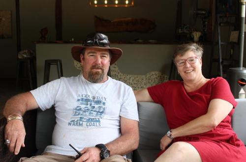 a man and a woman sitting on a couch at Lions Rock Rapids - Luxury Tented Camp in Hazyview
