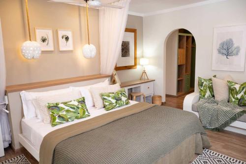 a bedroom with a bed and a chair at Indian Ocean Lodge in Grand'Anse Praslin
