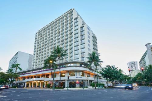 a tall building with palm trees in front of a street at OHANA Waikiki East by OUTRIGGER in Honolulu