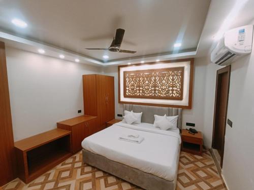 a bedroom with a large white bed in a room at Hotel Shaurya Inn in Lucknow