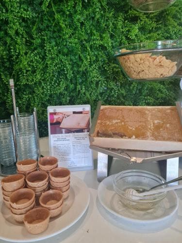 a table with a plate of brownies and a box of food at La Bussola Hotel Calabria in Capo Vaticano