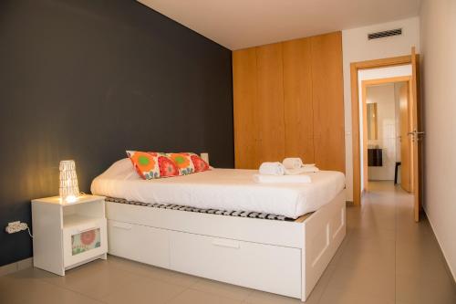 a bedroom with a white bed and a black wall at A17 - Heaven Sun Praia da Rocha 1 Bed Apartment in Portimão