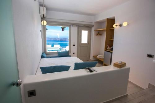 a bedroom with a bed and a view of the ocean at Caldera's Majesty in Imerovigli