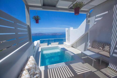 a swimming pool on the side of a house at Caldera's Majesty in Imerovigli