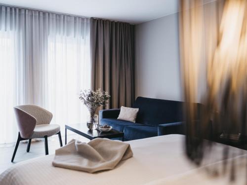 a hotel room with a bed and a couch at The Crystal VAYA Unique in Obergurgl