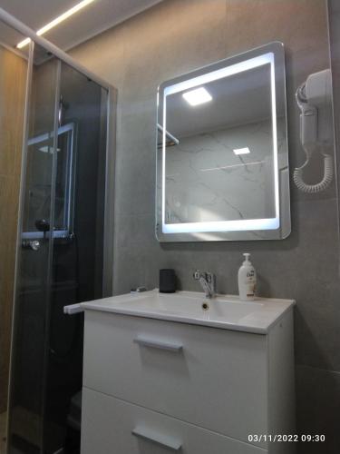 a bathroom with a sink and a mirror at Central loft at Teleferic in Sinaia
