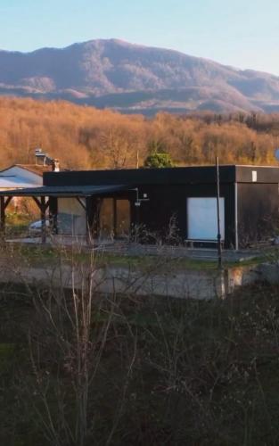 a black building with a mountain in the background at Villa a vamos 