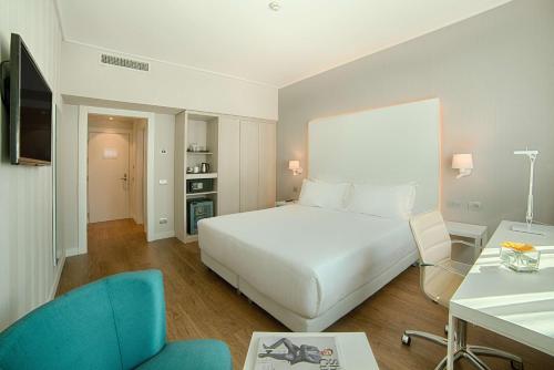 A bed or beds in a room at NH Torino Centro