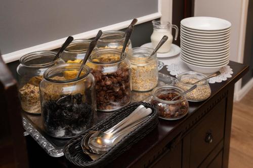 a counter with jars of food and dishes on it at Kanclerz in Zamość