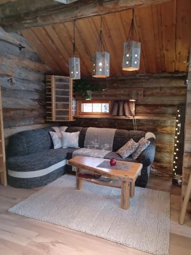 a living room with a couch and a coffee table at Rukan Kelostar in Kuusamo