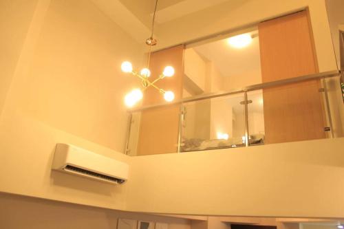 a mirror on a wall in a kitchen with a fan at A2J Luxury 3BR Suite Near Uptown Mall BGC Taguig in Manila