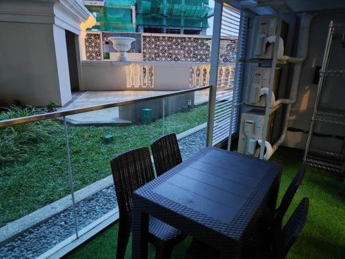 a table and chairs on the balcony of a house at A2J Luxury 3BR Suite Near Uptown Mall BGC Taguig in Manila