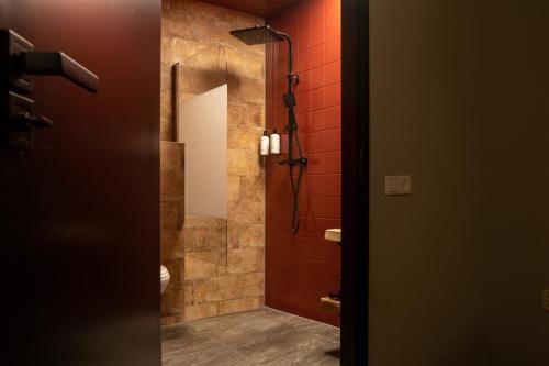 a bathroom with a shower and a toilet in a room at Boutique Hotel Four in Geldrop