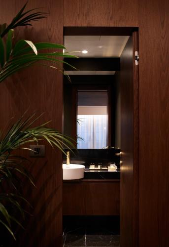 a bathroom with a sink and a mirror at Brown Acropol, a member of Brown Hotels in Athens
