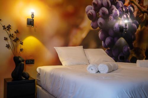 a bedroom with a bed with towels on it at Hotel Four in Geldrop