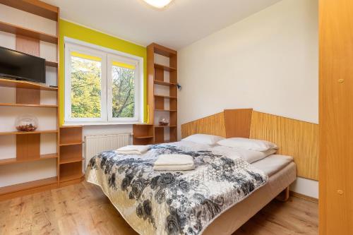 Posteľ alebo postele v izbe v ubytovaní Rezydencja Spacerowa Apartamenty by Noclegi Renters