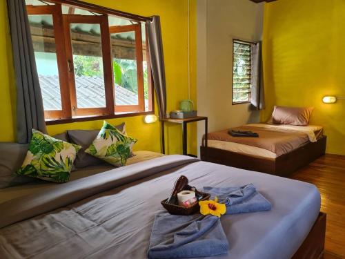 a bedroom with two beds and a window at Sleep Pai Bed & Breakfast in Pai