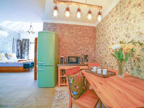 a living room with a green refrigerator and a wooden table at La Gomera Deluxe LOFT (1-3 Pers.) mit toller Aussicht in Valle Gran Rey