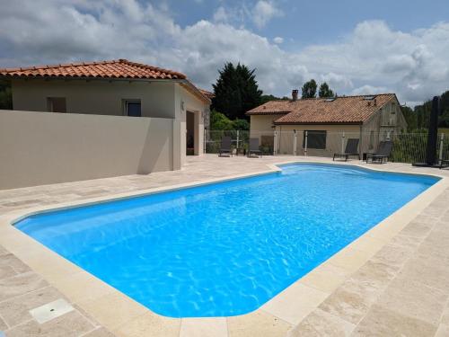 a large blue swimming pool in front of a house at Maison spacieuse en pleine nature avec piscine, équipements de loisirs et randonnées à proximité - FR-1-653-105 in Nonac