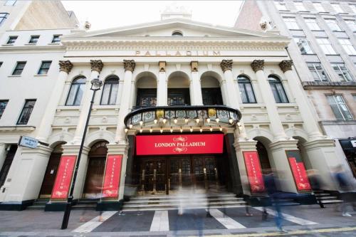 a building with a red sign on the front of it at Astor Court Hotel in London