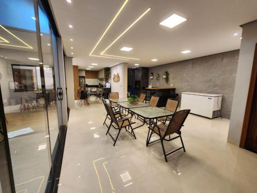 a dining room and kitchen with a table and chairs at Casa em Alter Do Chão, com piscina, próxima a praia. in Santarém