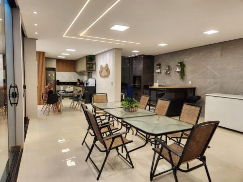 a dining room with a table and chairs at Casa em Alter Do Chão, com piscina, próxima a praia. in Santarém