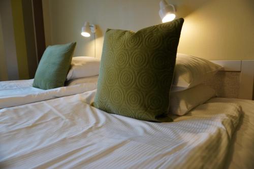 a bed with two pillows on top of it at Nygården Stjärnholm in Nyköping