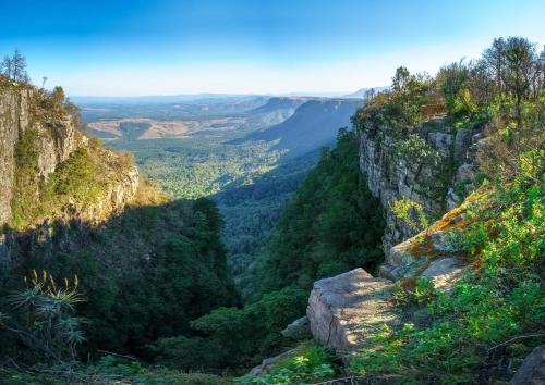 a view of the blue mountains from a cliff at Lions Rock Rapids - Luxury Tented Camp in Hazyview
