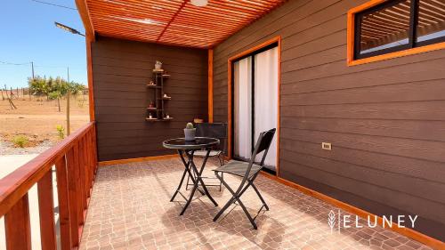 a patio with a table and a chair on a porch at ELUNEY Combarbala in Combarbalá