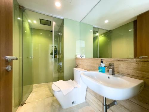 a bathroom with a sink and a shower and a toilet at Vortex suites klcc by Surat in Kuala Lumpur