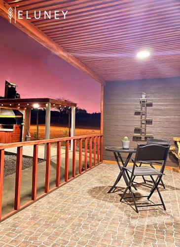 a patio with a table and a chair on a balcony at ELUNEY Combarbala in Combarbalá