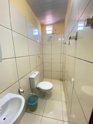 a bathroom with a toilet and a sink at Pousada do Ary in Jericoacoara