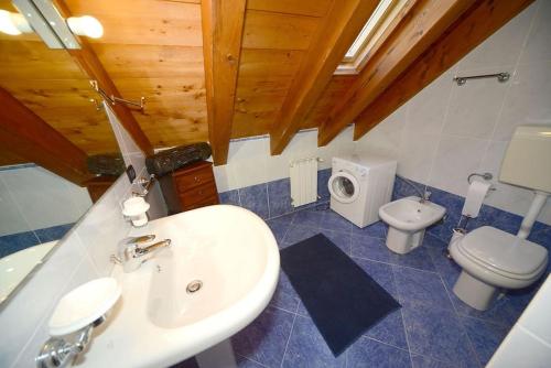 a bathroom with a sink and a toilet at Trilocale Alpinsun - Accoglienza per 5 persone in Sozzine