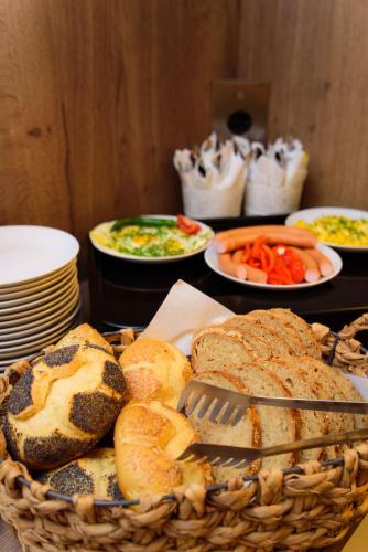 a basket filled with bread and vegetables on a table at Hotel TwentyFour Living in Bad Urach