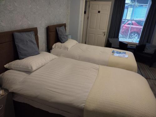 a hotel room with two beds in a room at 29 Well Street B&B in Moffat