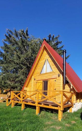 a small wooden cabin with a red roof at Aleksa’s chalet in Žabljak
