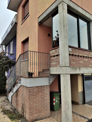 a building with a balcony on the side of it at Silver Home in Bagnolo San Vito