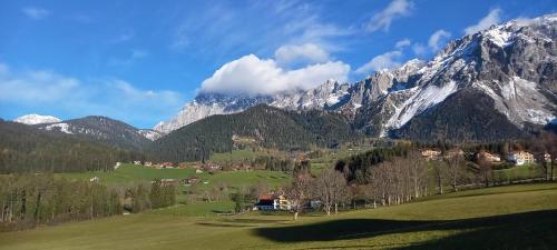 a mountain range with a village in a green field at Landhaus-Königsberg, Vorberg 360 Ebengütlweg in Ramsau am Dachstein