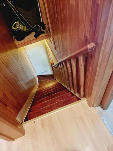 an overhead view of a wooden staircase with wood floors at maison de vacances in Halle